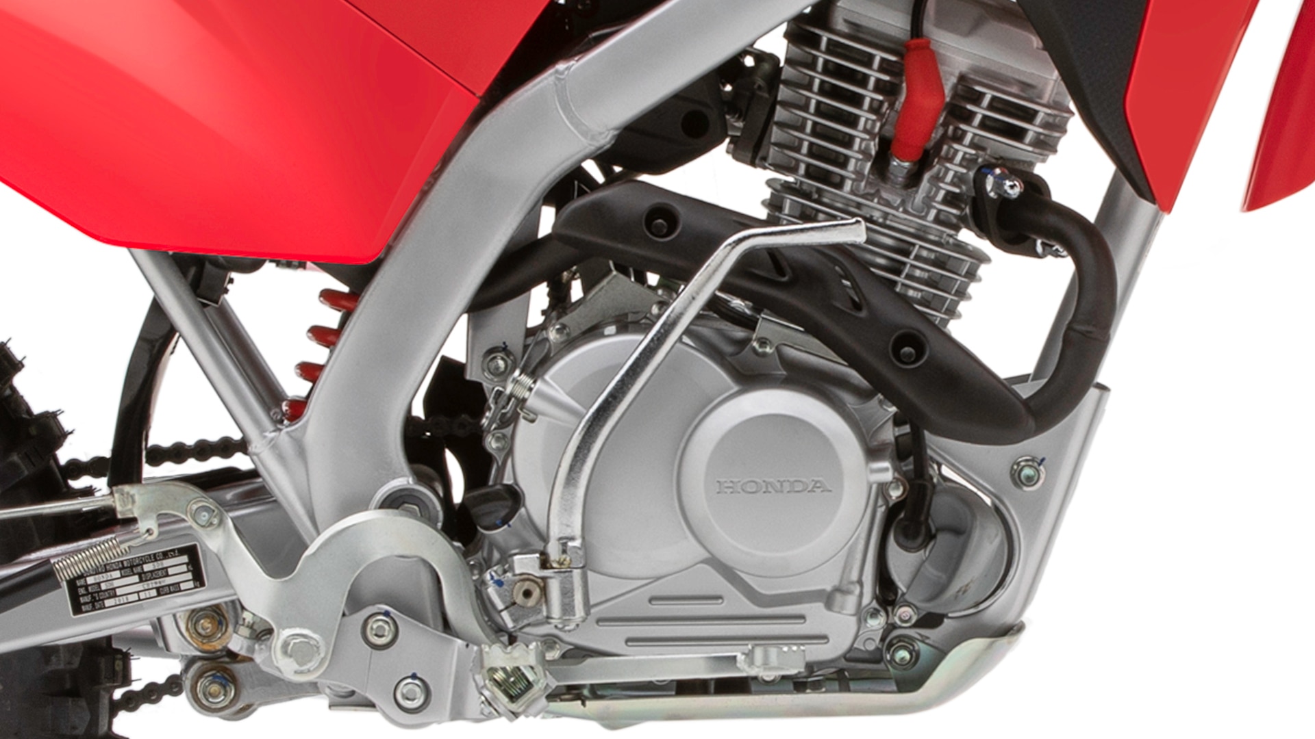 Close-up of 4-stroke air-cooled single-cylinder 125 cc engine and frame.